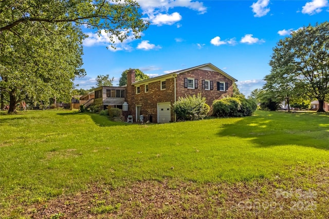 157 E Meadowview Dr, Statesville, NC 28625 - rear view of property featuring brick siding, a chimney, a garage, and a yard
