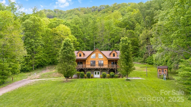 110 Mailon King Rd, Leicester, NC 28748 - view of front of property with a forest view, a front yard, a deck, and dirt driveway
