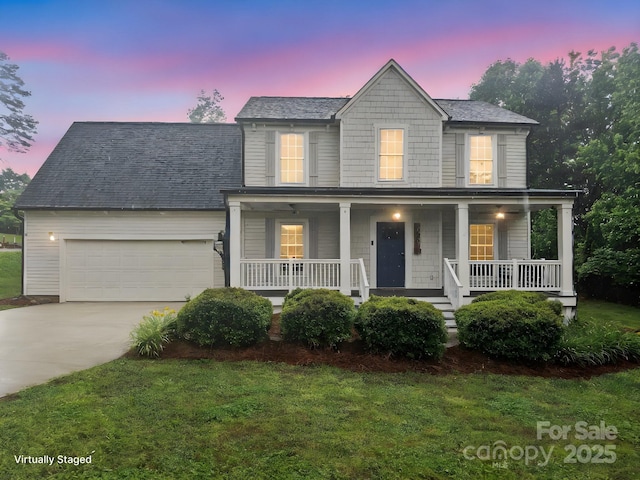 10749 Kingsview Dr, Davidson, NC 28036 - view of front of home with a porch, a garage, driveway, and a front lawn