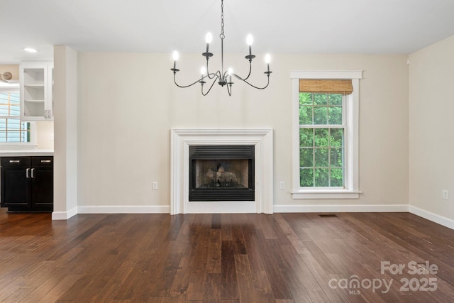 10749 Kingsview Dr, Davidson, NC 28036 - unfurnished living room featuring a chandelier, dark wood-style flooring, baseboards, and a fireplace