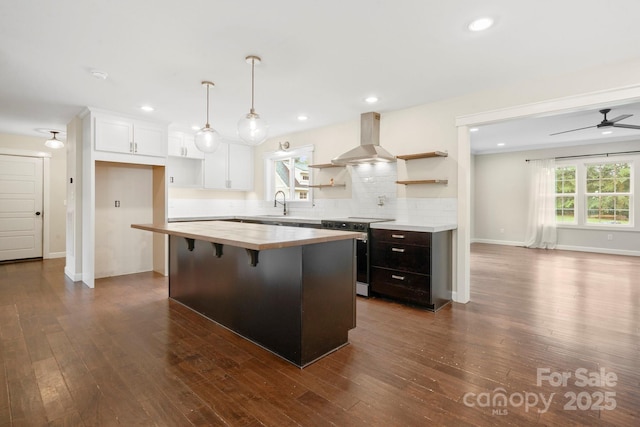 10749 Kingsview Dr, Davidson, NC 28036 - kitchen featuring stainless steel electric range, wall chimney range hood, open shelves, wooden counters, and decorative backsplash