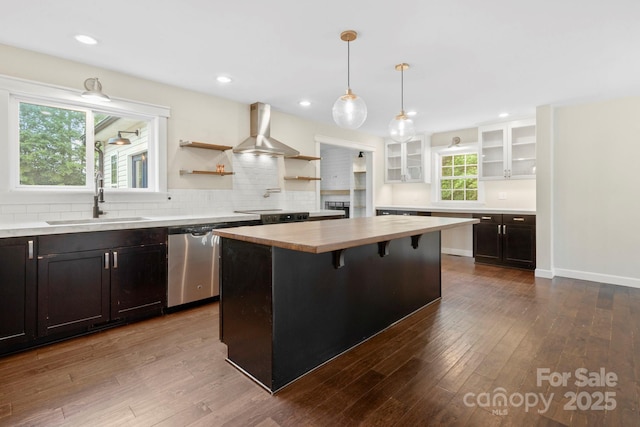 10749 Kingsview Dr, Davidson, NC 28036 - kitchen featuring wood counters, a sink, wall chimney exhaust hood, glass insert cabinets, and dark wood-style floors