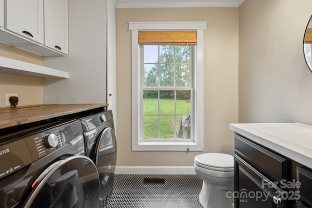 10749 Kingsview Dr, Davidson, NC 28036 - clothes washing area with washing machine and clothes dryer, baseboards, ornamental molding, and tile patterned floors