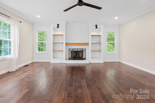 10749 Kingsview Dr, Davidson, NC 28036 - unfurnished living room featuring a brick fireplace, plenty of natural light, ceiling fan, wood finished floors, and ornamental molding