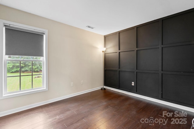 10749 Kingsview Dr, Davidson, NC 28036 - unfurnished bedroom with baseboards and dark wood-style flooring