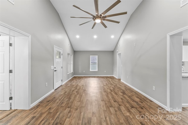 800 Hoyle St SW, Valdese, NC 28690 - unfurnished living room with high vaulted ceiling, a ceiling fan, wood finished floors, baseboards, and recessed lighting