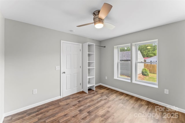 800 Hoyle St SW, Valdese, NC 28690 - unfurnished bedroom featuring wood finished floors, baseboards, and ceiling fan