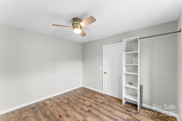 800 Hoyle St SW, Valdese, NC 28690 - unfurnished bedroom with baseboards, wood finished floors, and ceiling fan