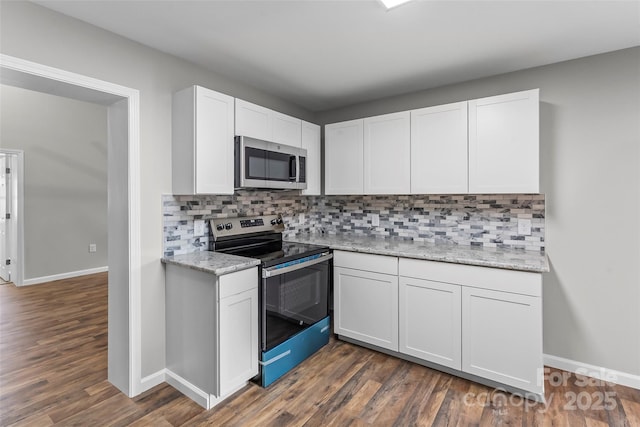 800 Hoyle St SW, Valdese, NC 28690 - kitchen with stainless steel appliances, white cabinetry, baseboards, and dark wood-style floors