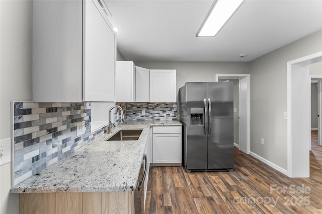 800 Hoyle St SW, Valdese, NC 28690 - kitchen with stainless steel appliances, a sink, backsplash, light stone counters, and dark wood finished floors