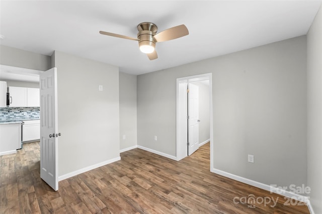 800 Hoyle St SW, Valdese, NC 28690 - spare room with a ceiling fan, wood finished floors, and baseboards