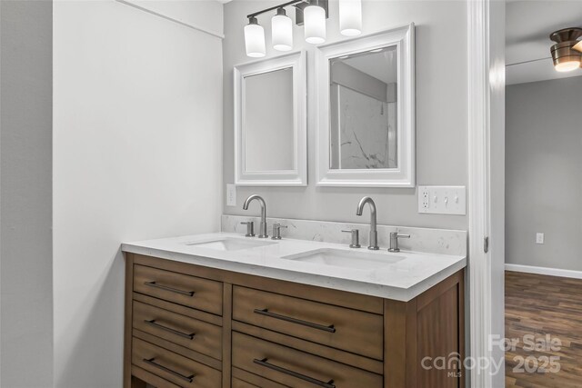 800 Hoyle St SW, Valdese, NC 28690 - bathroom featuring double vanity, wood finished floors, and baseboards