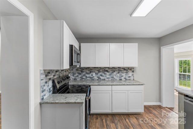800 Hoyle St SW, Valdese, NC 28690 - kitchen with appliances with stainless steel finishes, dark wood-style flooring, white cabinets, backsplash, and light stone counters