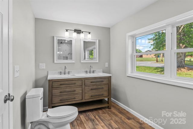 800 Hoyle St SW, Valdese, NC 28690 - bathroom featuring toilet, wood finished floors, double vanity, and baseboards