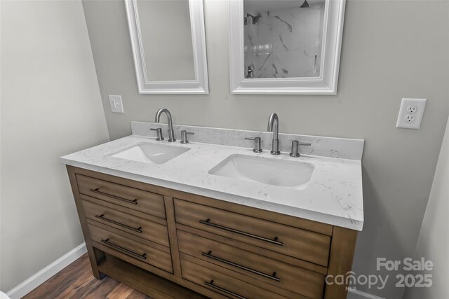 800 Hoyle St SW, Valdese, NC 28690 - bathroom featuring double vanity, wood finished floors, and baseboards