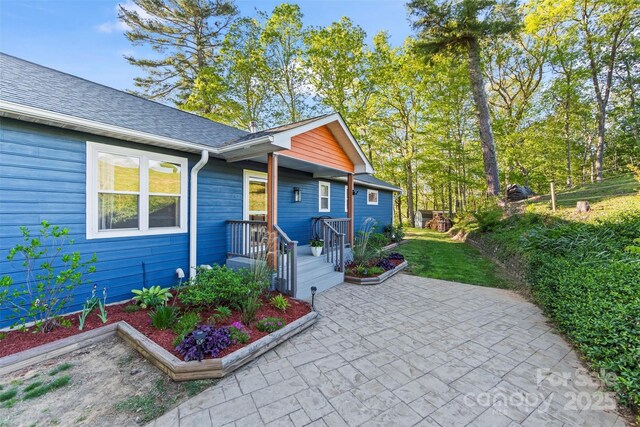84 Halfmoon Way, Clyde, NC 28721 - view of front of house with a patio area and a shingled roof