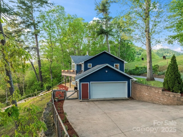 84 Halfmoon Way, Clyde, NC 28721 - view of front of house with a gate, a garage, fence, a deck, and driveway