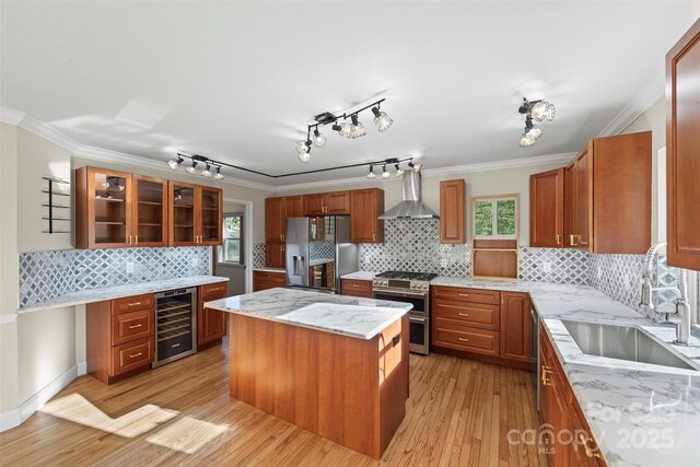 84 Halfmoon Way, Clyde, NC 28721 - kitchen featuring wine cooler, stainless steel appliances, wall chimney exhaust hood, a sink, and healthy amount of natural light