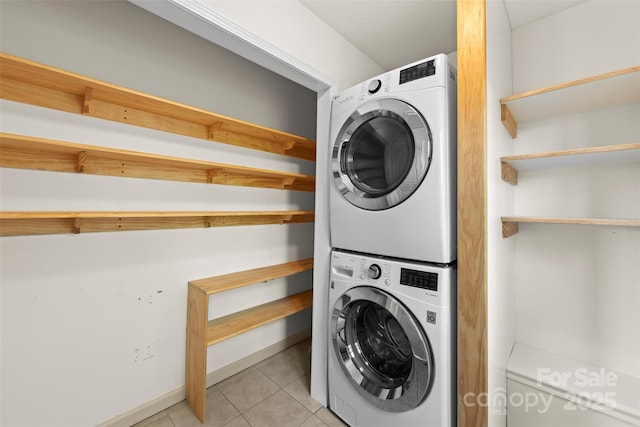 84 Halfmoon Way, Clyde, NC 28721 - laundry area with stacked washing machine and dryer, light tile patterned floors, and baseboards