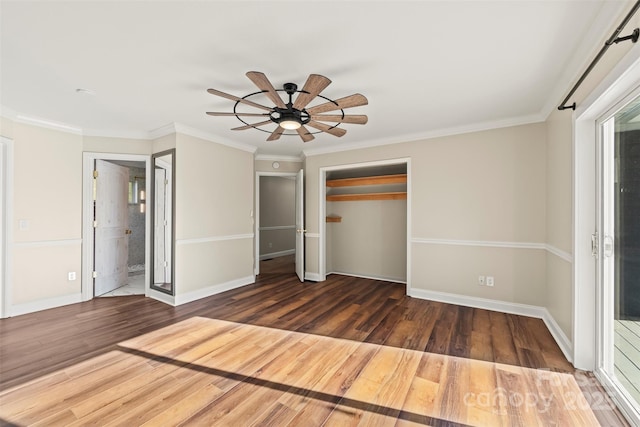 84 Halfmoon Way, Clyde, NC 28721 - unfurnished bedroom with wood finished floors, a closet, ornamental molding, baseboards, and a ceiling fan