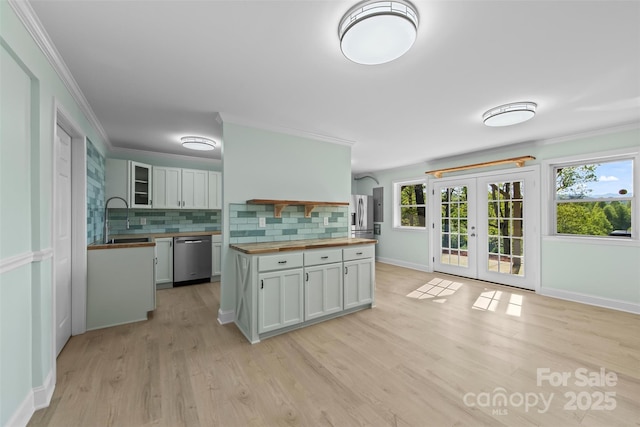 84 Halfmoon Way, Clyde, NC 28721 - kitchen with butcher block counters, appliances with stainless steel finishes, a sink, decorative backsplash, and french doors