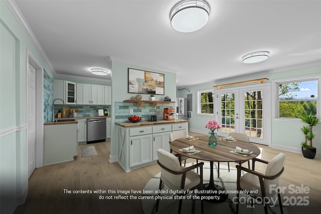 84 Halfmoon Way, Clyde, NC 28721 - dining room featuring french doors, light wood-style flooring, healthy amount of natural light, ornamental molding, and baseboards