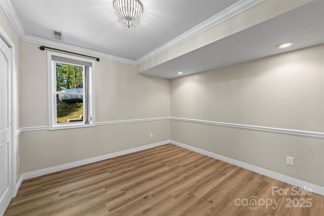 84 Halfmoon Way, Clyde, NC 28721 - empty room featuring baseboards, wood finished floors, ornamental molding, and recessed lighting