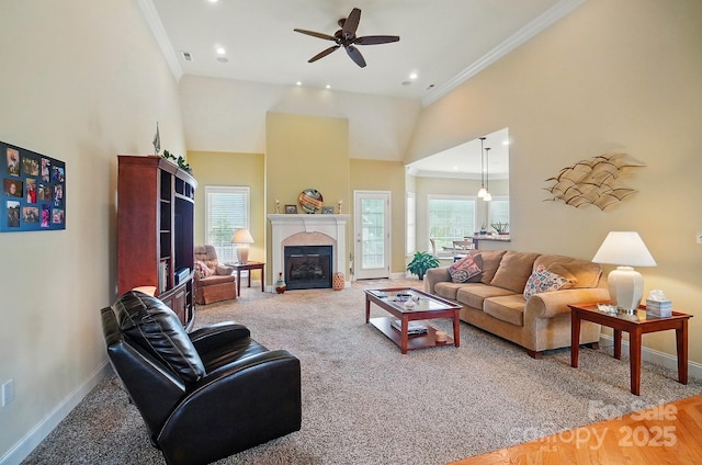 129 Daniel Efird Dr, Mount Holly, NC 28120 - living room with baseboards, crown molding, ceiling fan, a fireplace with flush hearth, and a high ceiling