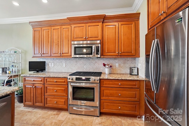129 Daniel Efird Dr, Mount Holly, NC 28120 - kitchen featuring appliances with stainless steel finishes, backsplash, ornamental molding, light stone counters, and brown cabinets