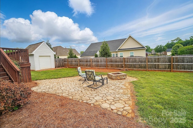 129 Daniel Efird Dr, Mount Holly, NC 28120 - view of yard featuring a fire pit, a patio area, and an outbuilding
