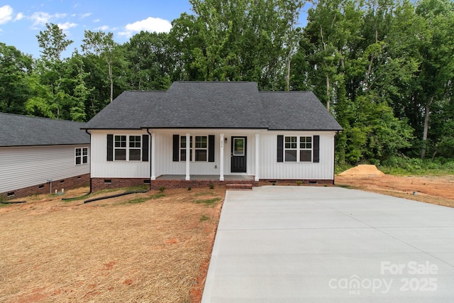 894 Oval St, Kannapolis, NC 28081 - view of front facade featuring crawl space, a shingled roof, a porch, and driveway