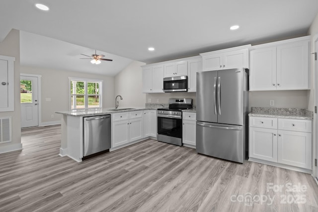 894 Oval St, Kannapolis, NC 28081 - kitchen with appliances with stainless steel finishes, a sink, ceiling fan, a peninsula, and white cabinetry