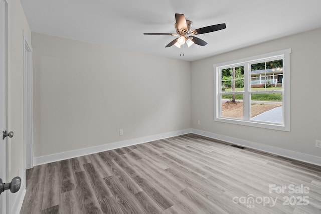 894 Oval St, Kannapolis, NC 28081 - empty room with wood finished floors, a ceiling fan, and baseboards