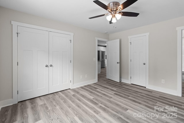 894 Oval St, Kannapolis, NC 28081 - unfurnished bedroom featuring freestanding refrigerator, baseboards, light wood-style floors, a closet, and a ceiling fan