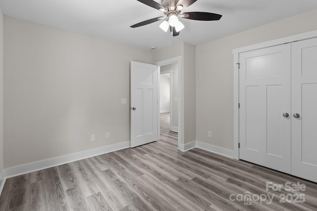 894 Oval St, Kannapolis, NC 28081 - unfurnished bedroom with wood finished floors, baseboards, a closet, and a ceiling fan