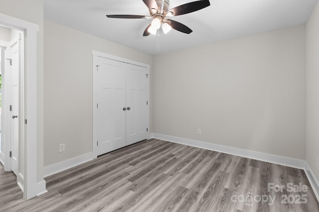 894 Oval St, Kannapolis, NC 28081 - unfurnished bedroom with light wood-style flooring, a closet, baseboards, and a ceiling fan
