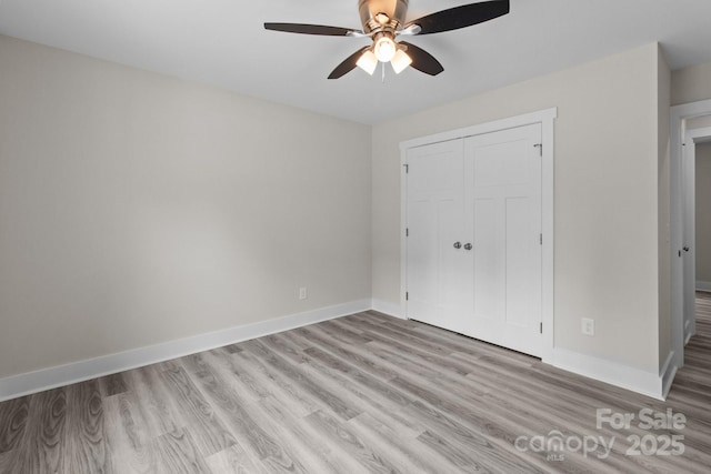 894 Oval St, Kannapolis, NC 28081 - unfurnished bedroom featuring light wood-style floors, a closet, baseboards, and a ceiling fan
