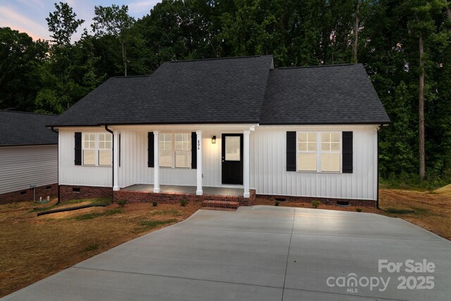 894 Oval St, Kannapolis, NC 28081 - view of front of home with crawl space, covered porch, and roof with shingles