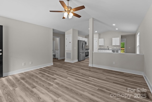 896 Oval St, Kannapolis, NC 28081 - unfurnished living room featuring lofted ceiling, ceiling fan, light wood finished floors, baseboards, and recessed lighting