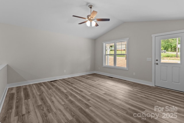 896 Oval St, Kannapolis, NC 28081 - unfurnished room with vaulted ceiling, a ceiling fan, wood finished floors, and baseboards