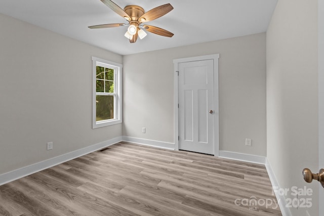 896 Oval St, Kannapolis, NC 28081 - spare room with a ceiling fan, wood finished floors, and baseboards