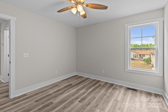 896 Oval St, Kannapolis, NC 28081 - unfurnished room featuring light wood-style floors, ceiling fan, and baseboards