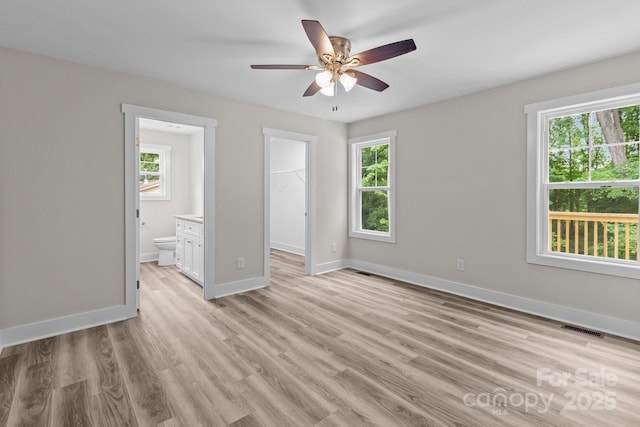 896 Oval St, Kannapolis, NC 28081 - unfurnished bedroom featuring a spacious closet, baseboards, light wood-type flooring, ensuite bath, and a closet