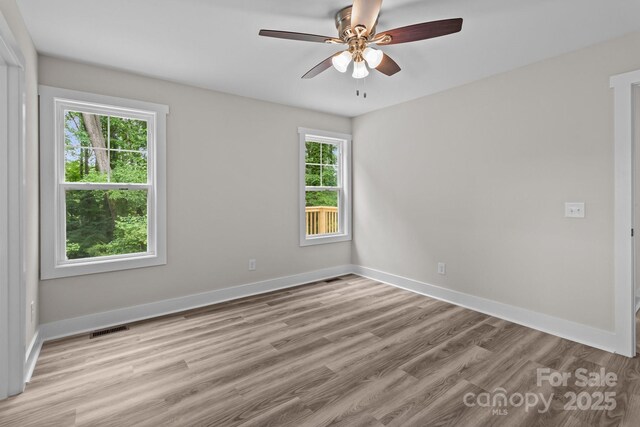 896 Oval St, Kannapolis, NC 28081 - empty room featuring light wood-style flooring, a ceiling fan, and baseboards