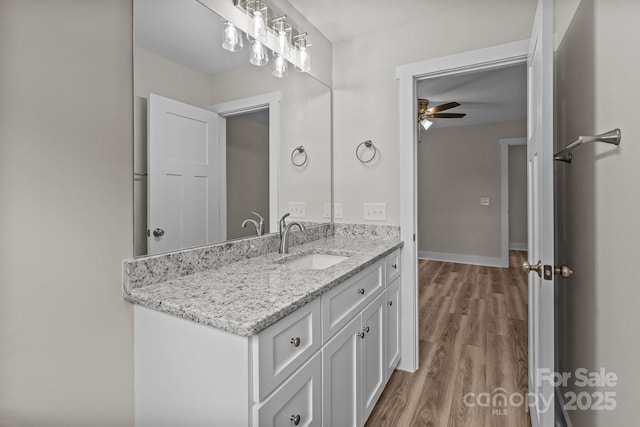 896 Oval St, Kannapolis, NC 28081 - bathroom with wood finished floors, a ceiling fan, vanity, and baseboards