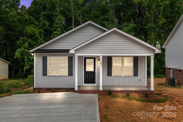 896 Oval St, Kannapolis, NC 28081 - bungalow-style home featuring a porch, crawl space, central air condition unit, and board and batten siding