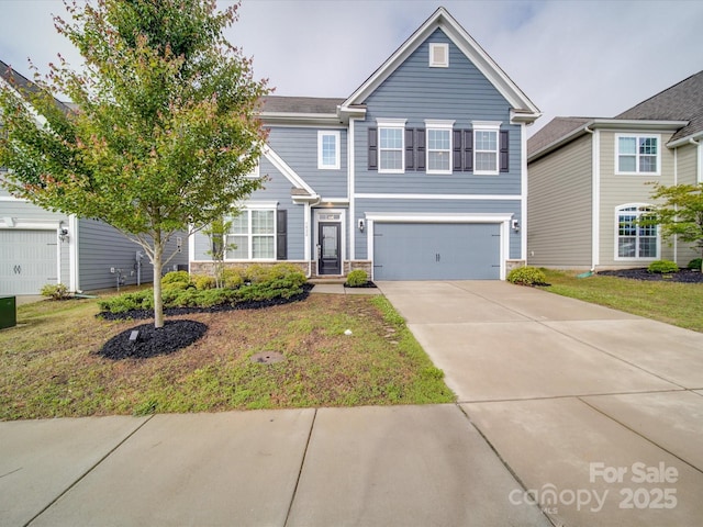 view of front of house featuring an attached garage, concrete driveway, stone siding, and a front yard