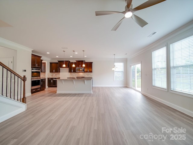 unfurnished living room featuring crown molding, light wood-style floors, recessed lighting, stairs, and baseboards