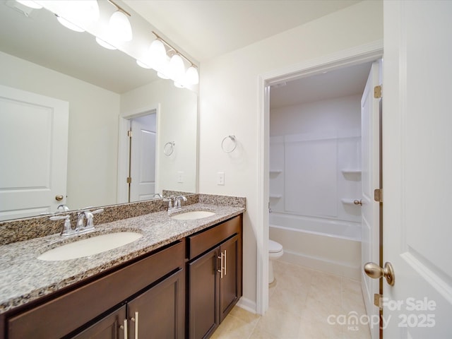 bathroom featuring toilet, double vanity, and tile patterned flooring