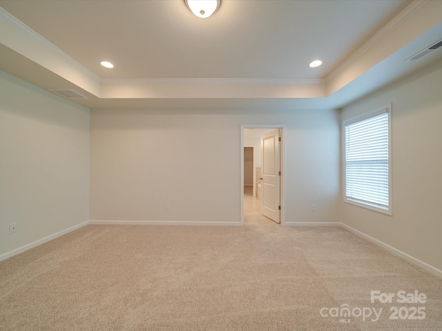 unfurnished room with a raised ceiling, crown molding, light carpet, baseboards, and recessed lighting